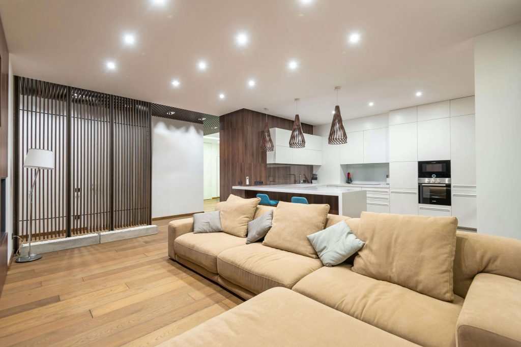 A modern open-plan living room with layered ambient lighting