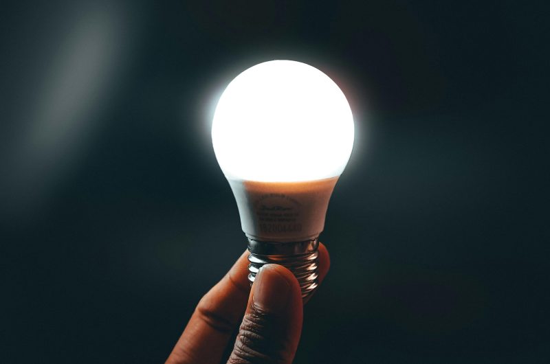 A glowing smart bulb held in hand, working without Wi-Fi