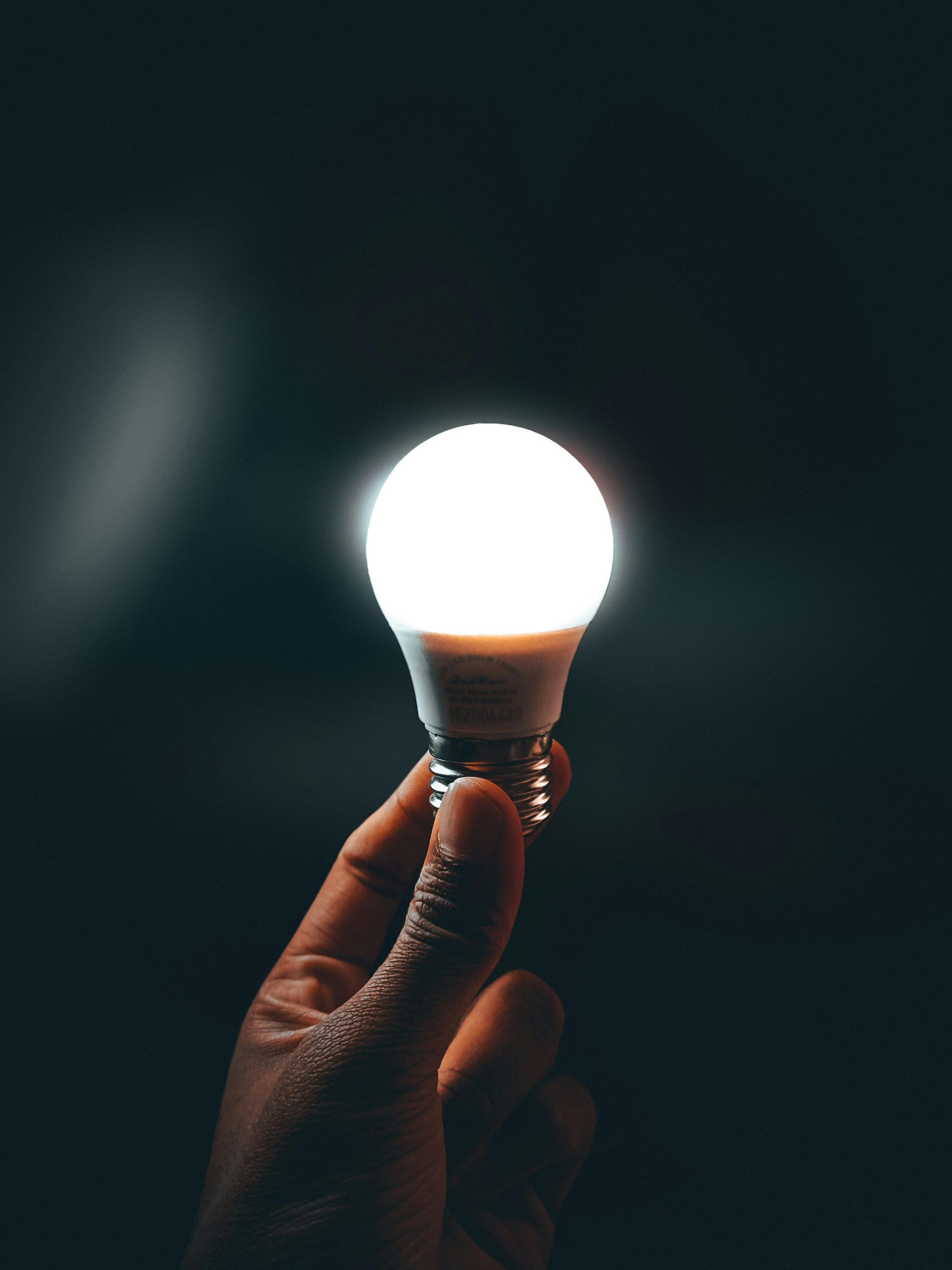 A glowing smart bulb held in hand, working without Wi-Fi