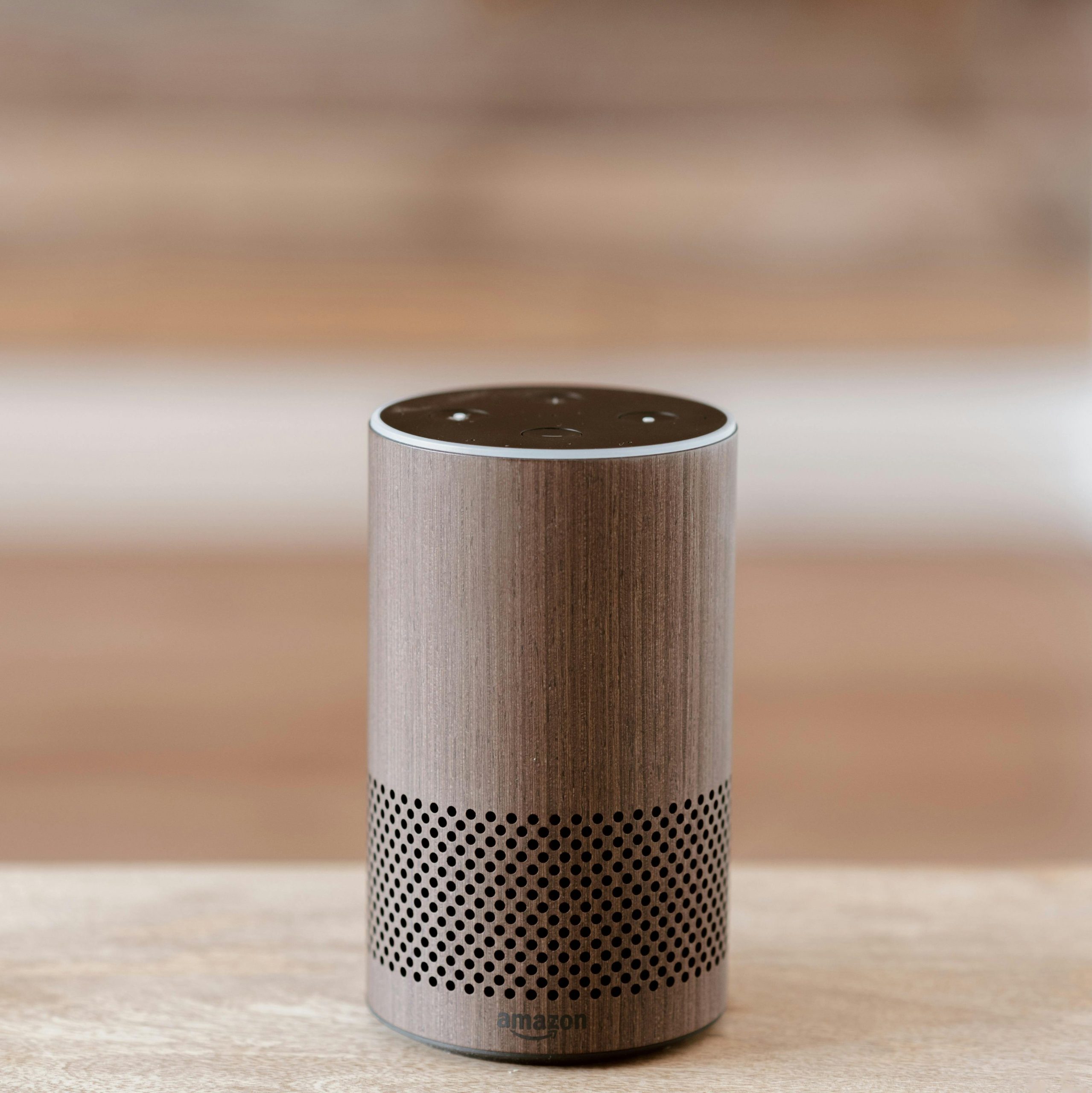 An Amazon Echo smart speaker on a wooden surface