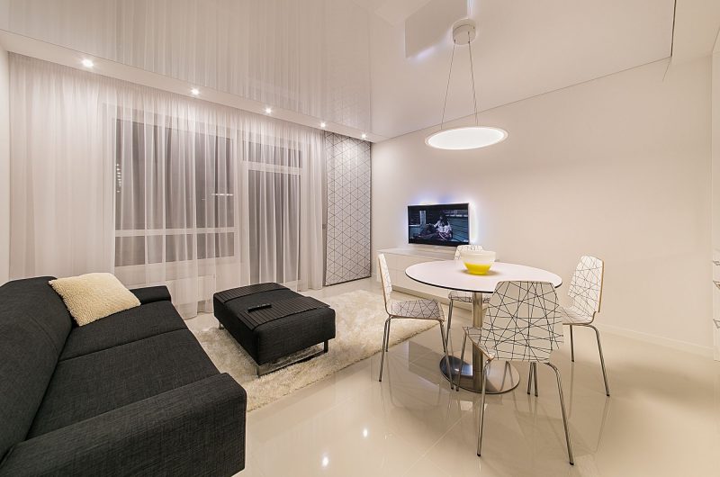 A modern living room showing different lighting types, illustrating smart bulbs vs smart switches choices