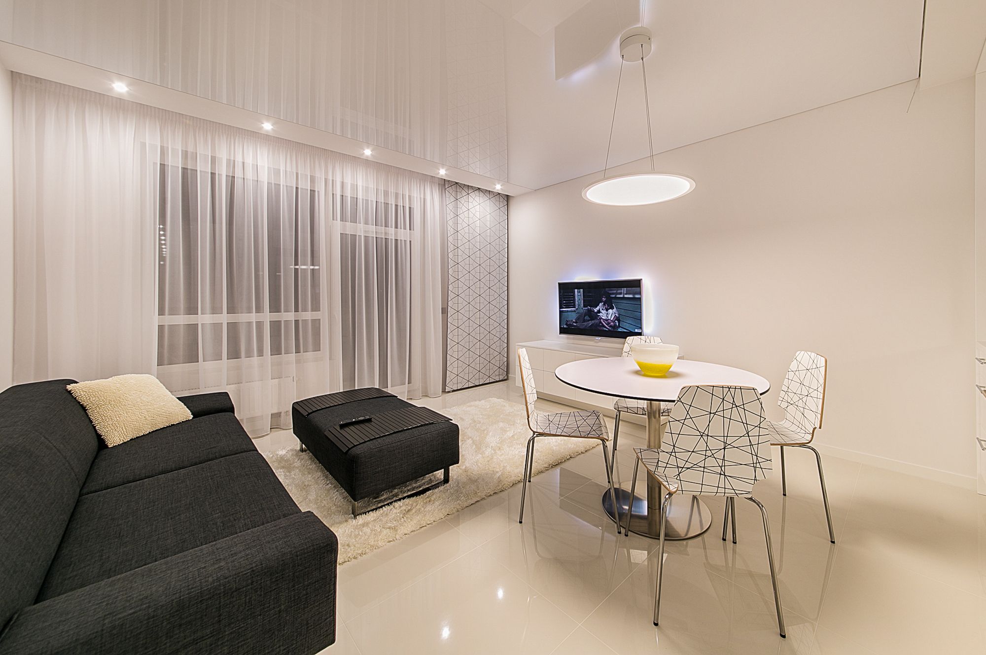A modern living room showing different lighting types, illustrating smart bulbs vs smart switches choices