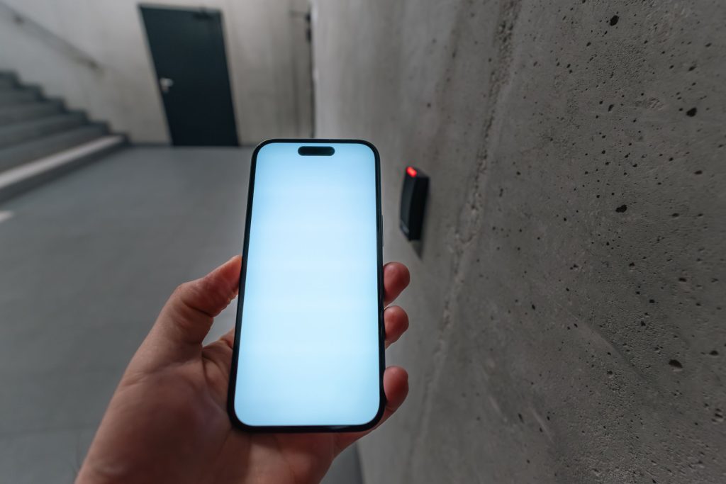 A person using a smartphone to unlock a smart door system