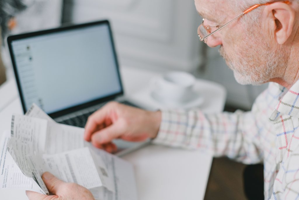 A person reviewing energy bills at home to check household expenses