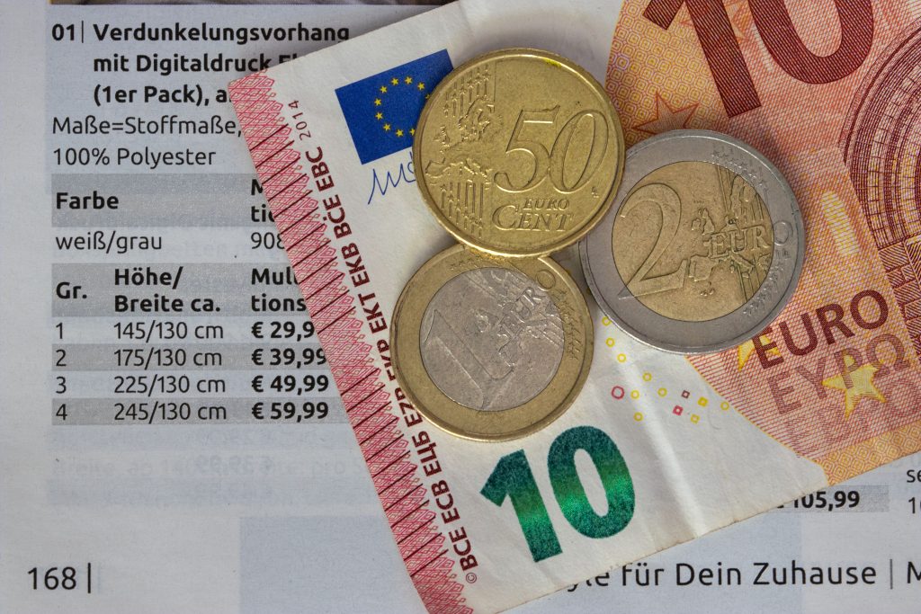 Energy bills and coins representing the real cost and savings from smart home devices