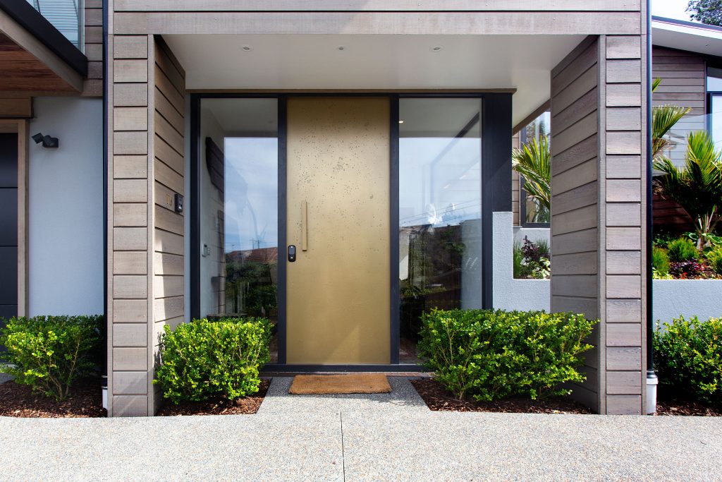 A modern smart home entrance with a connected door lock and security system