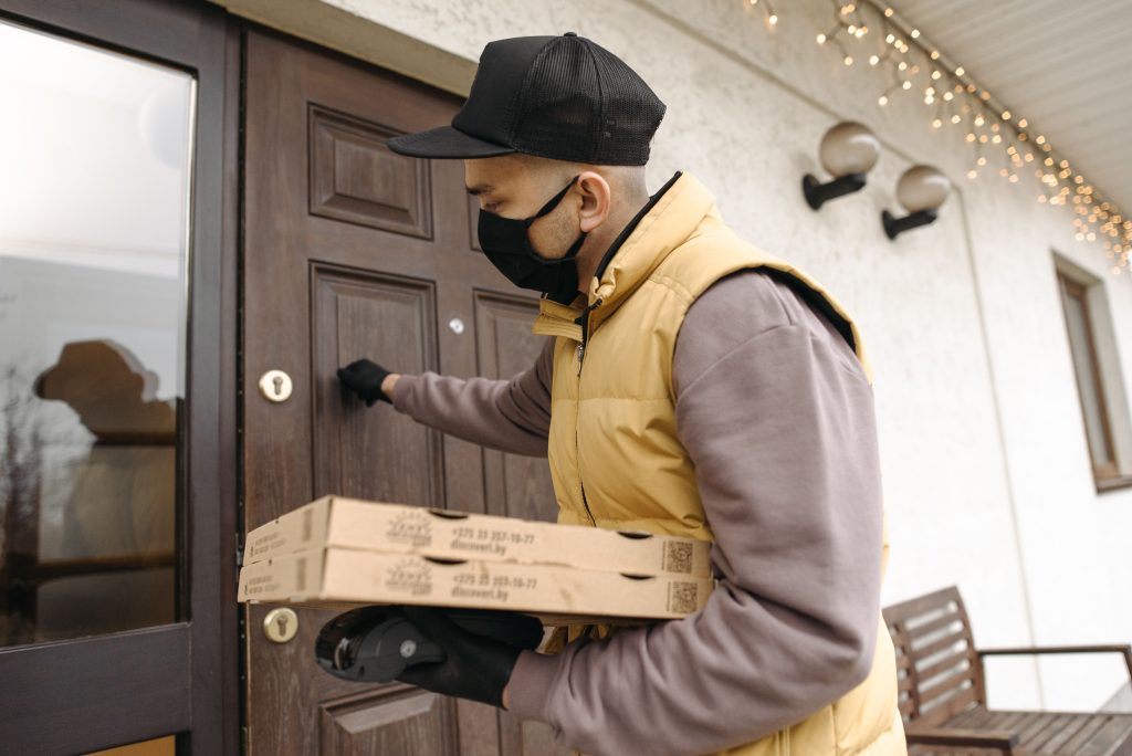 A delivery person at the front door, the most common use case for smart doorbells