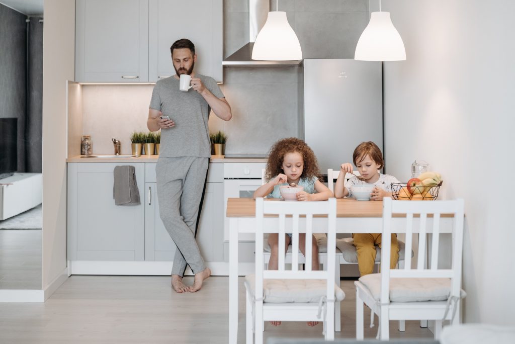 A family starting their morning routine in a modern kitchen