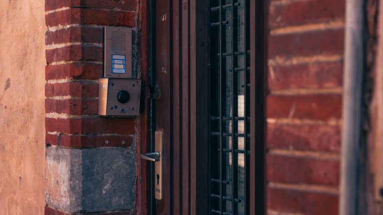 Are smart doorbells worth it — a video doorbell and intercom installed on a brick wall