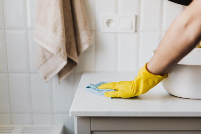 Smart home water leak detector placed under kitchen sink to prevent water damage